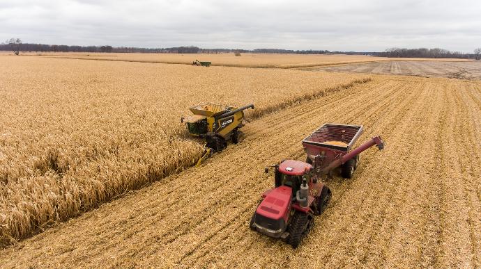 red and black tractor on brown field during daytime